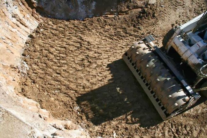 A bulldozer is digging a hole in the dirt