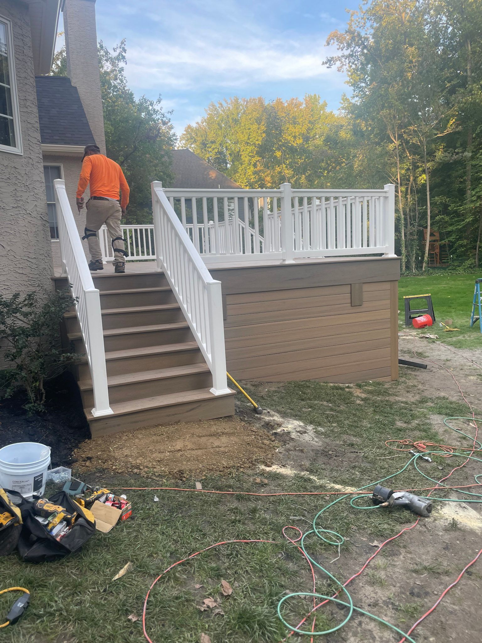 a man is standing on the stairs of a deck .