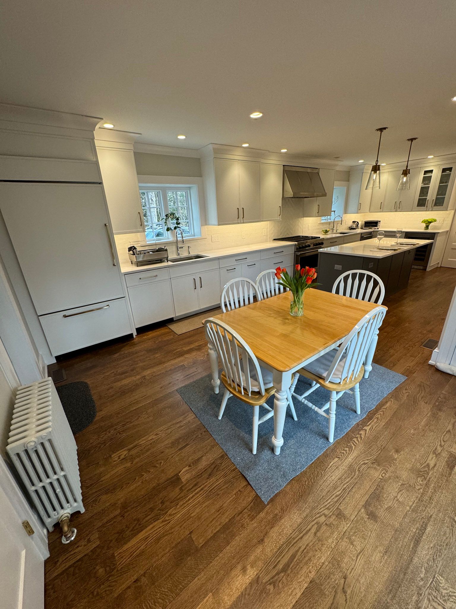 a kitchen with a dining table and chairs in it .