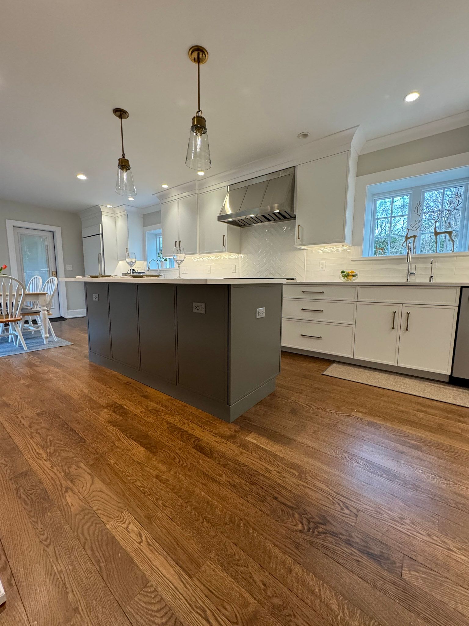 there is a large island in the middle of the kitchen .
