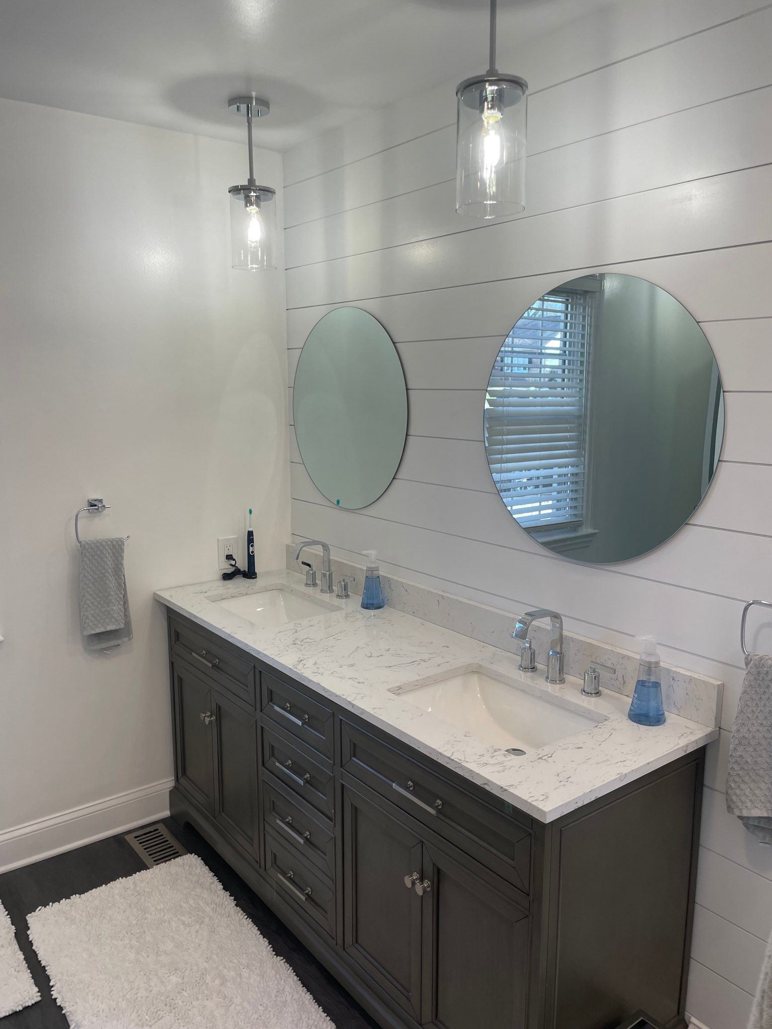 a bathroom with two sinks and two mirrors .