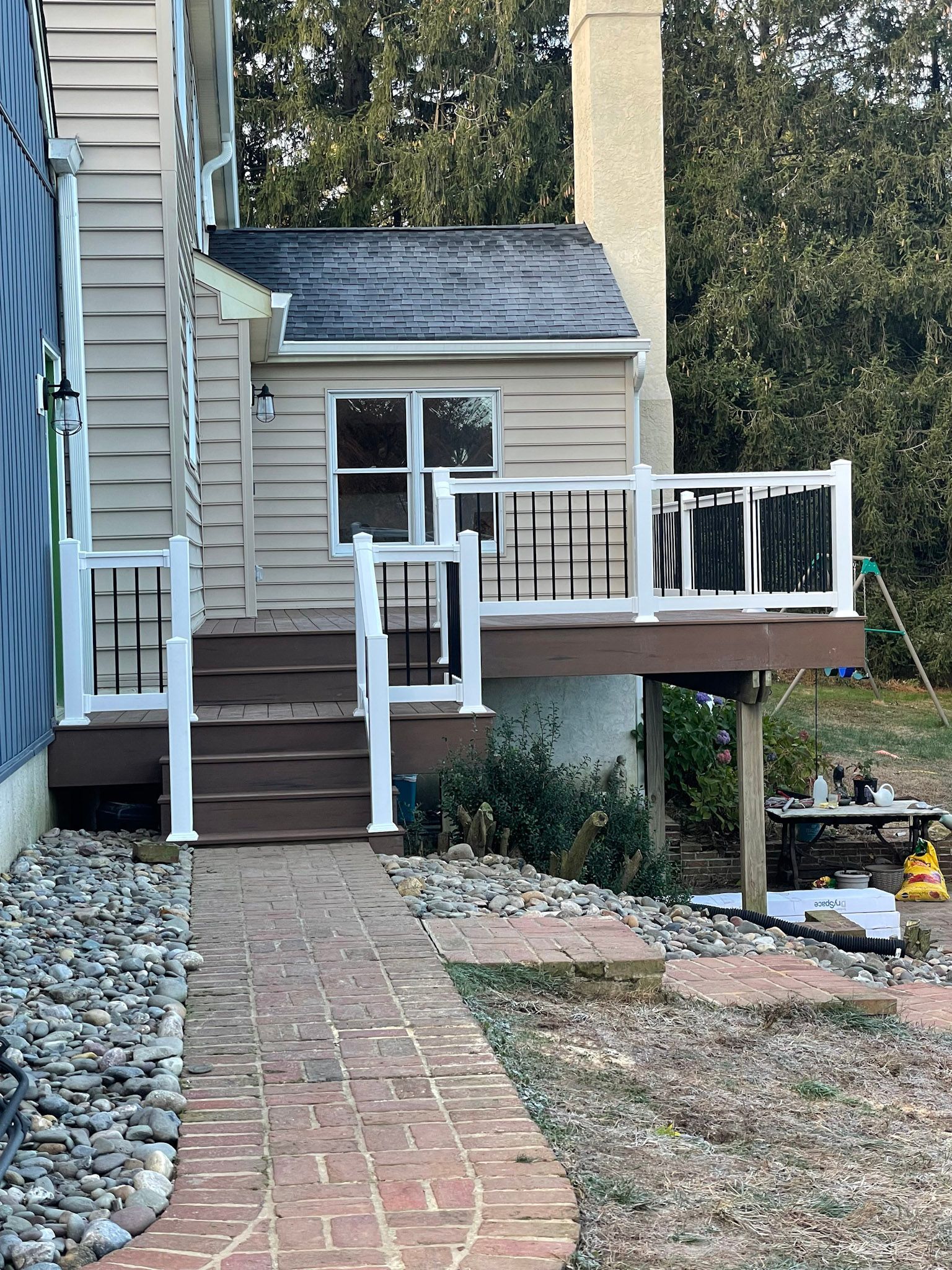 a house with a deck and stairs leading to it .