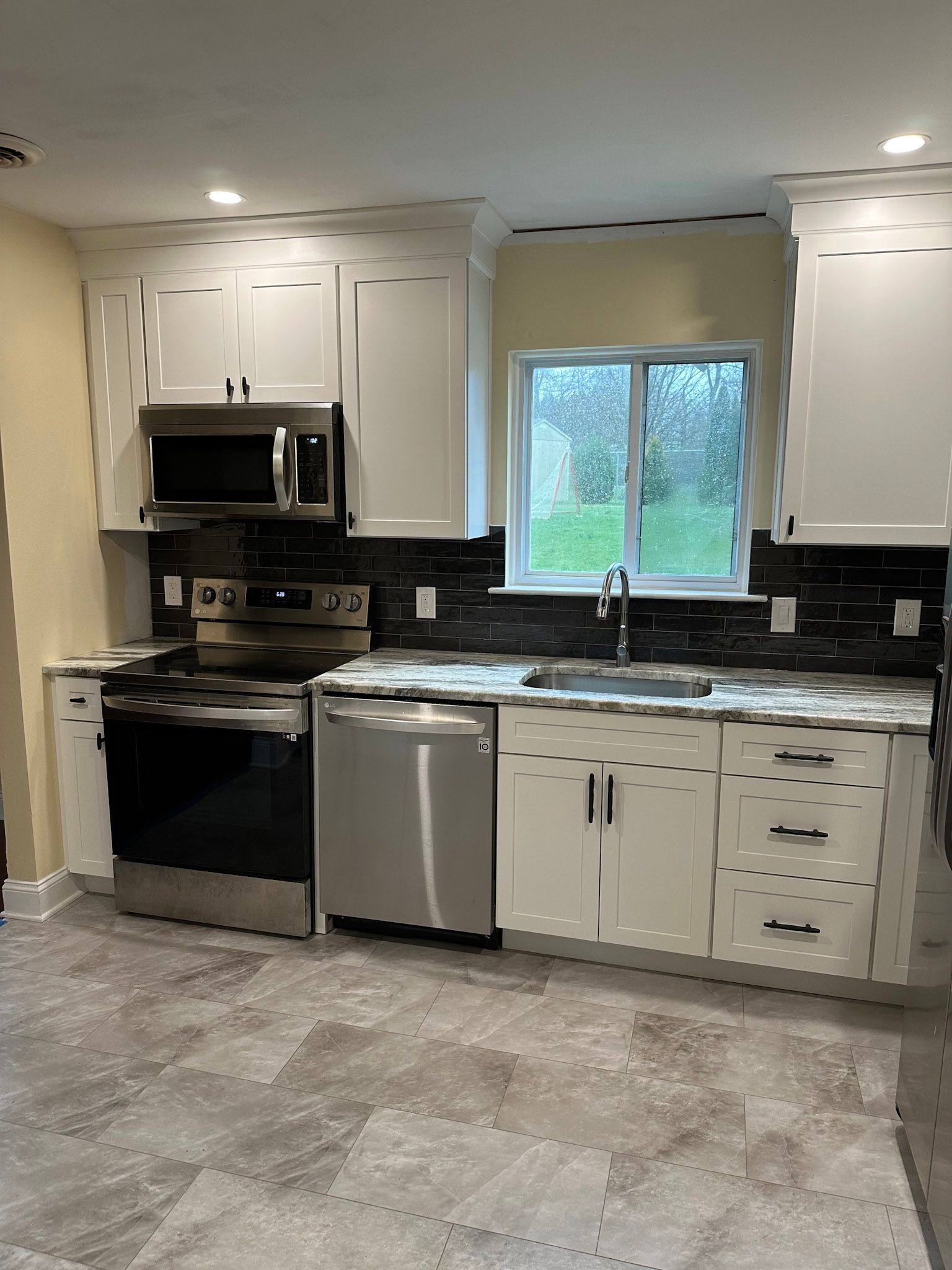 a kitchen with stainless steel appliances and white cabinets