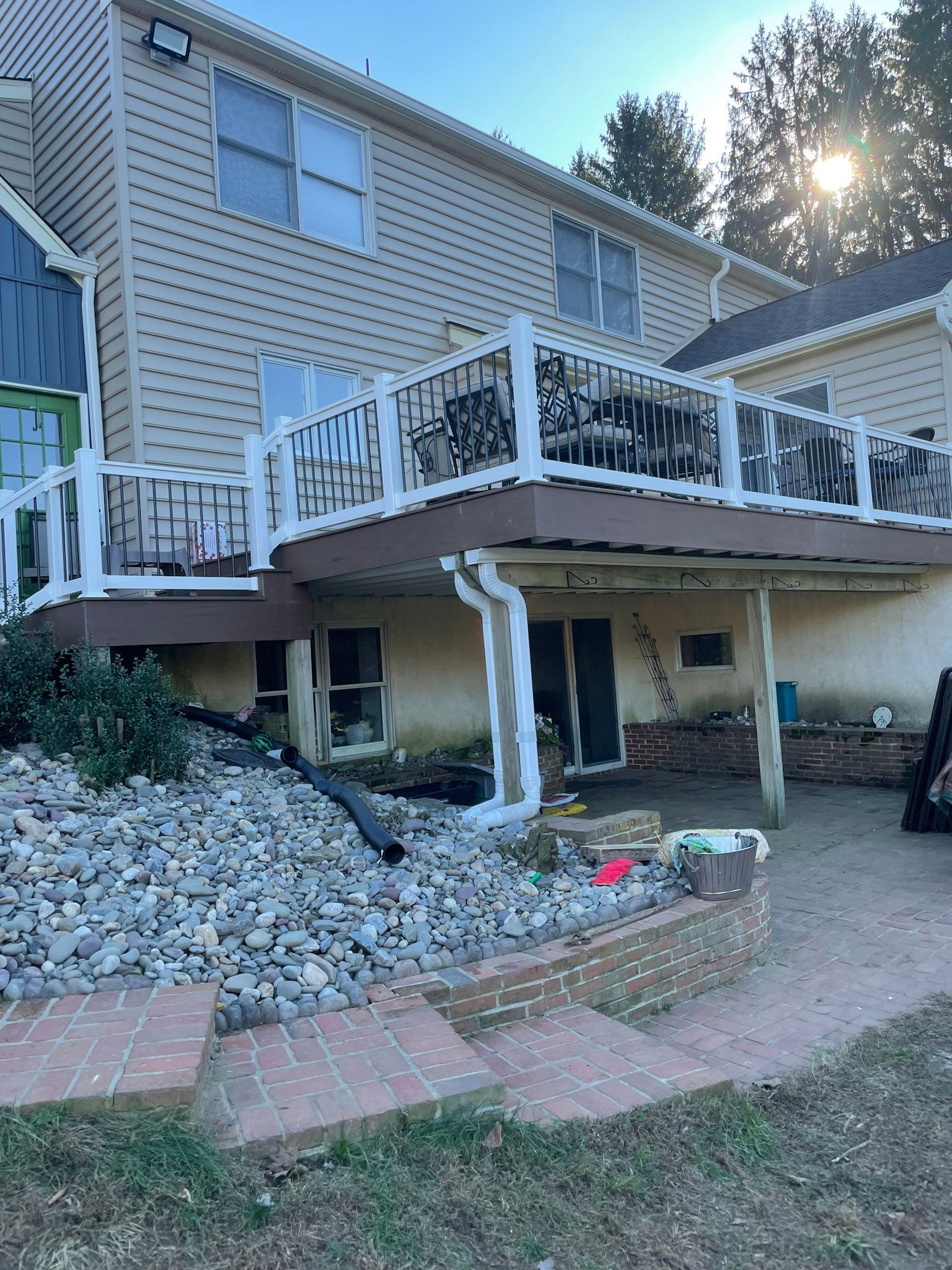 a house with a large deck and a carport underneath it .