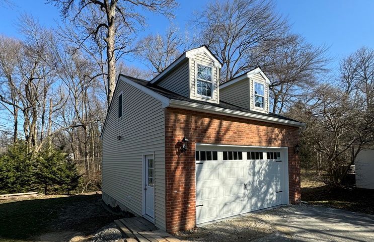 a garage with a brick wall and a white garage door .