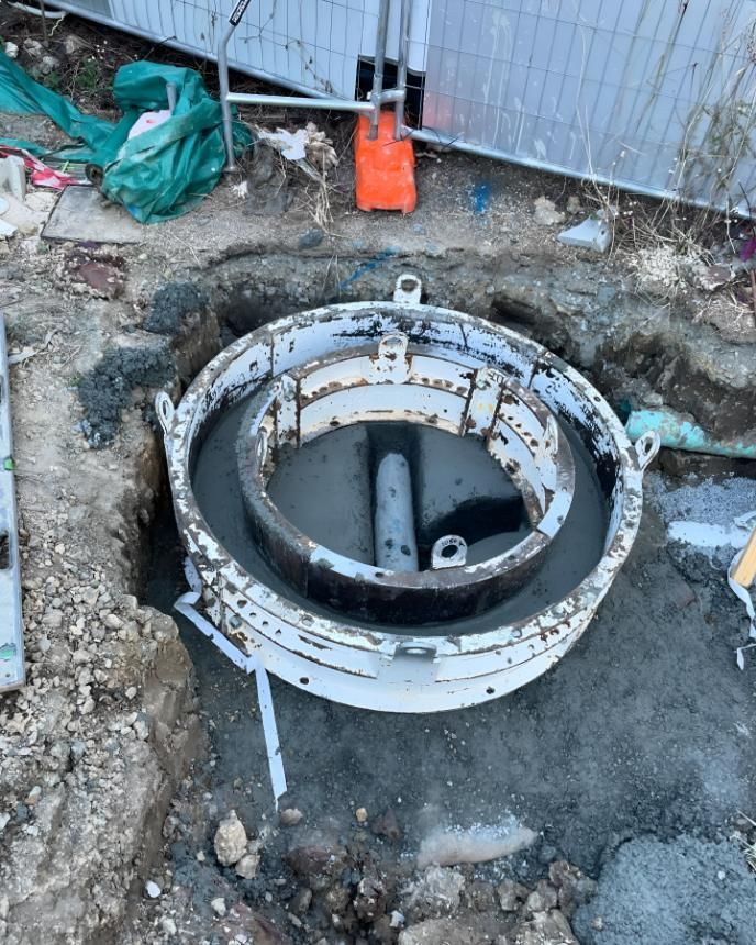 Manhole Cover is Being Built in a Hole in the Ground — Luke Barry Plumbing in Pimpama, QLD