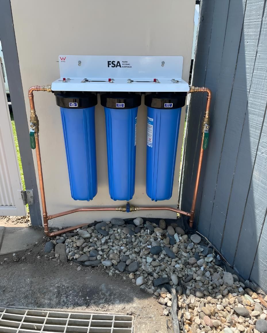 Water Filter is Installed on the Side of a Building — Luke Barry Plumbing in Oxenford, QLD