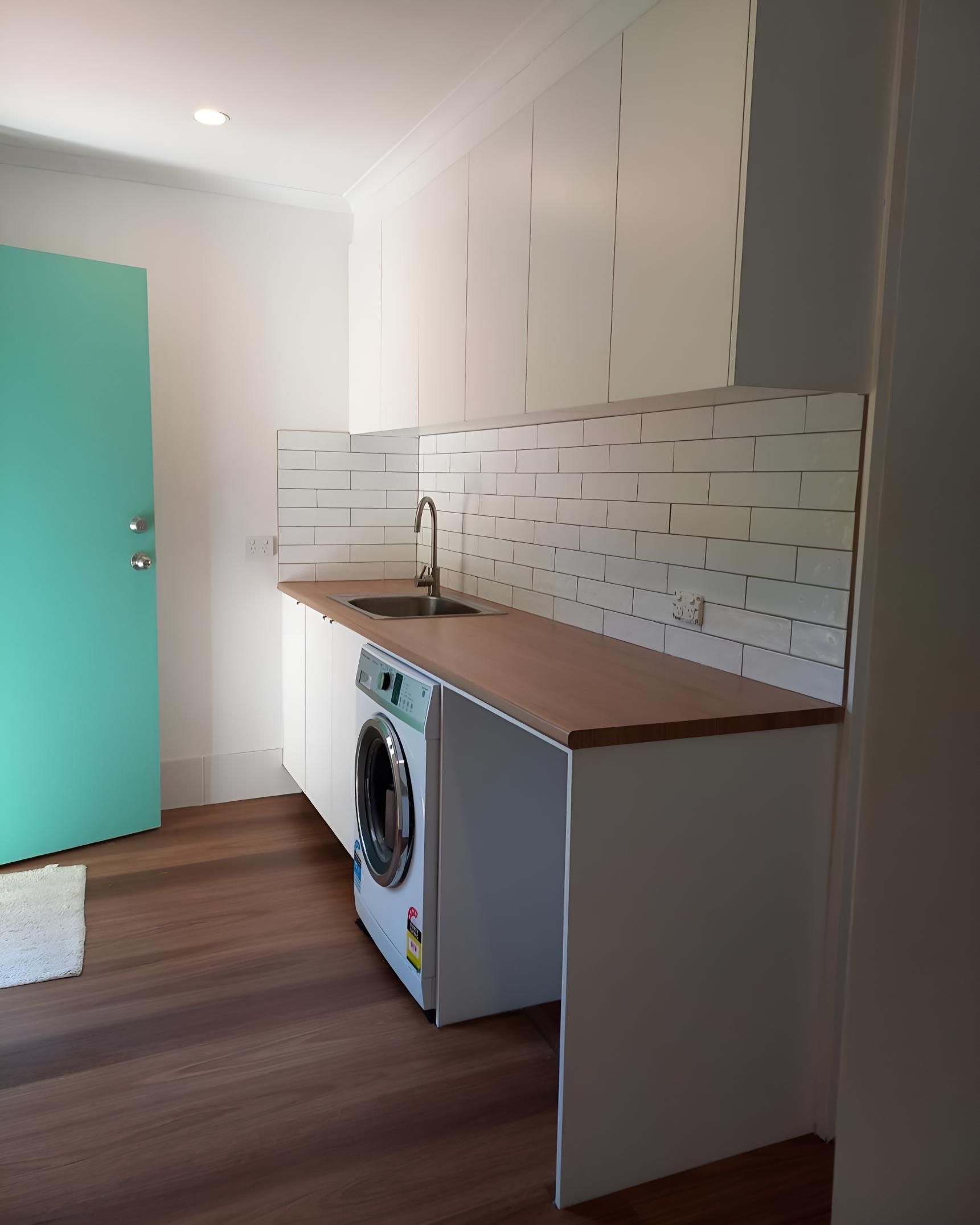 Laundry Room With a Washing Machine and a Sink — Luke Barry Plumbing in Mermaid Waters, QLD