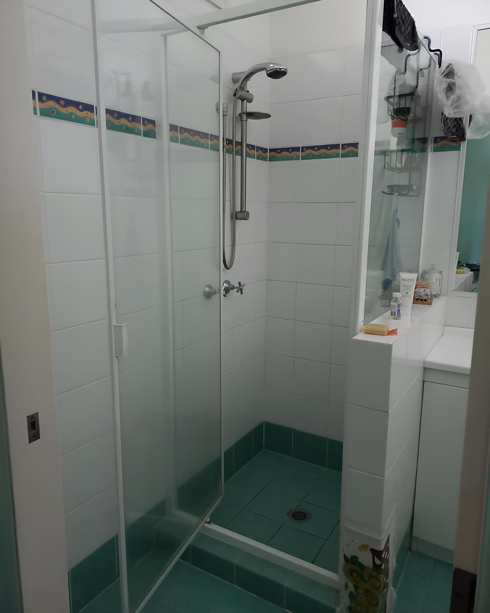 Bathroom With a Walk in Shower and a Mirror — Luke Barry Plumbing in Mermaid Beach, QLD