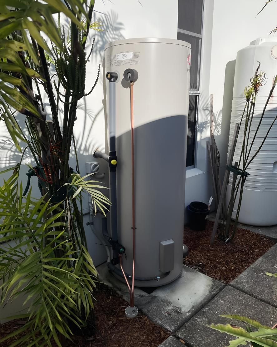 Water Heater is Sitting on a Sidewalk — Luke Barry Plumbing in Sanctuary Cove, QLD