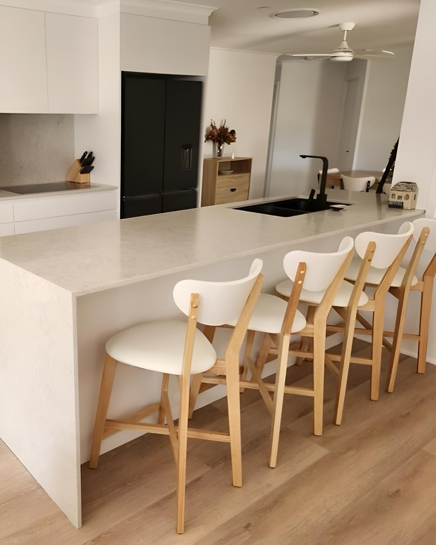 Kitchen With White Counter Tops and Wooden Chairs — Luke Barry Plumbing in Tugun, QLD