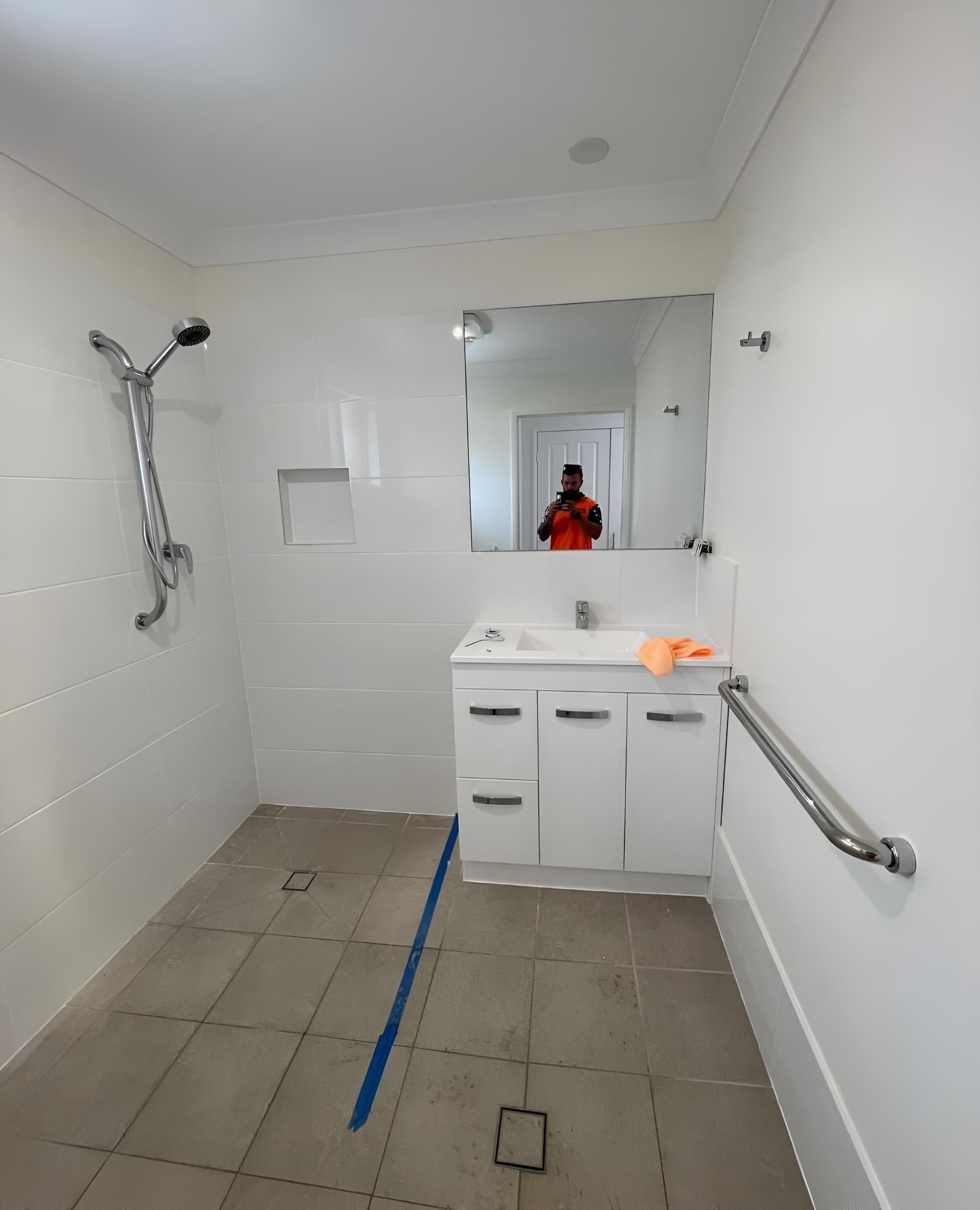 Bathroom With a Sink a Mirror and a Shower — Luke Barry Plumbing in Hope Island, QLD