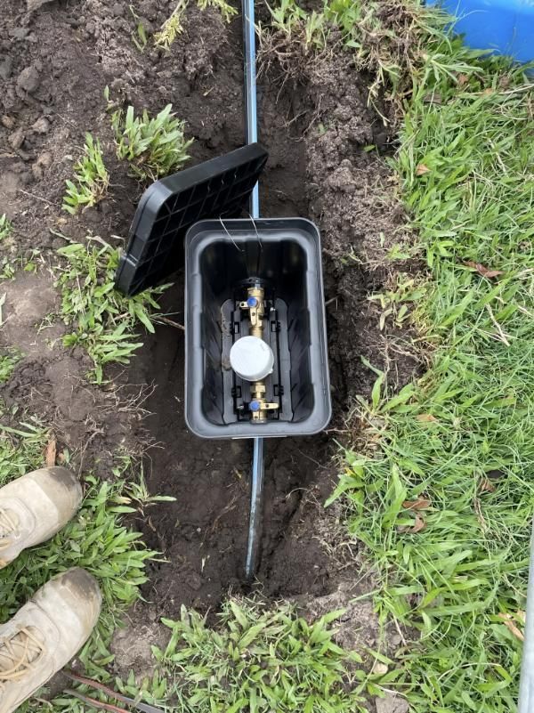 Water Meter is Sitting in the Dirt in the Grass — Luke Barry Plumbing in Palm Beach, QLD