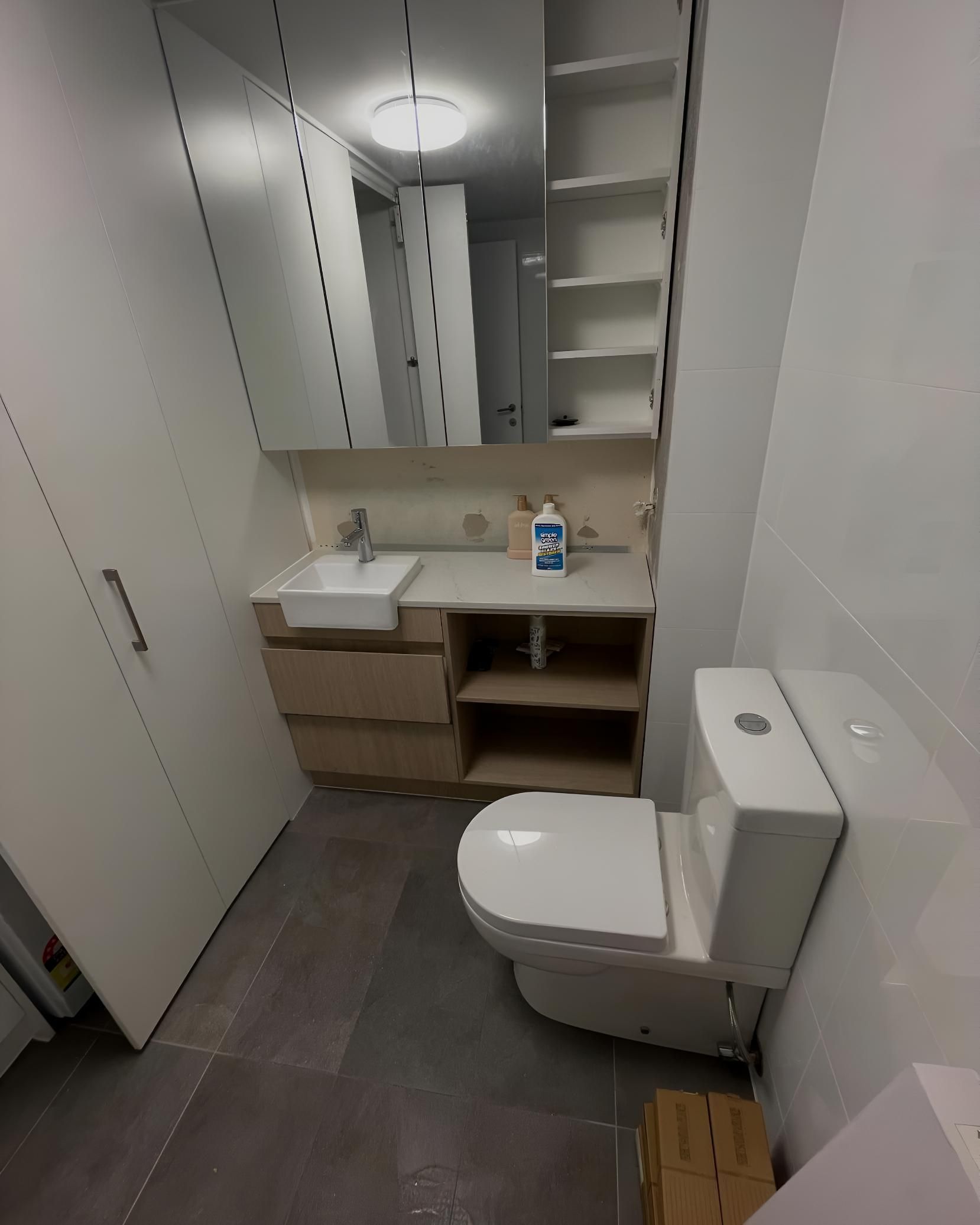 Bathroom With a Toilet a Sink and a Mirror — Luke Barry Plumbing in Upper Coomera, QLD
