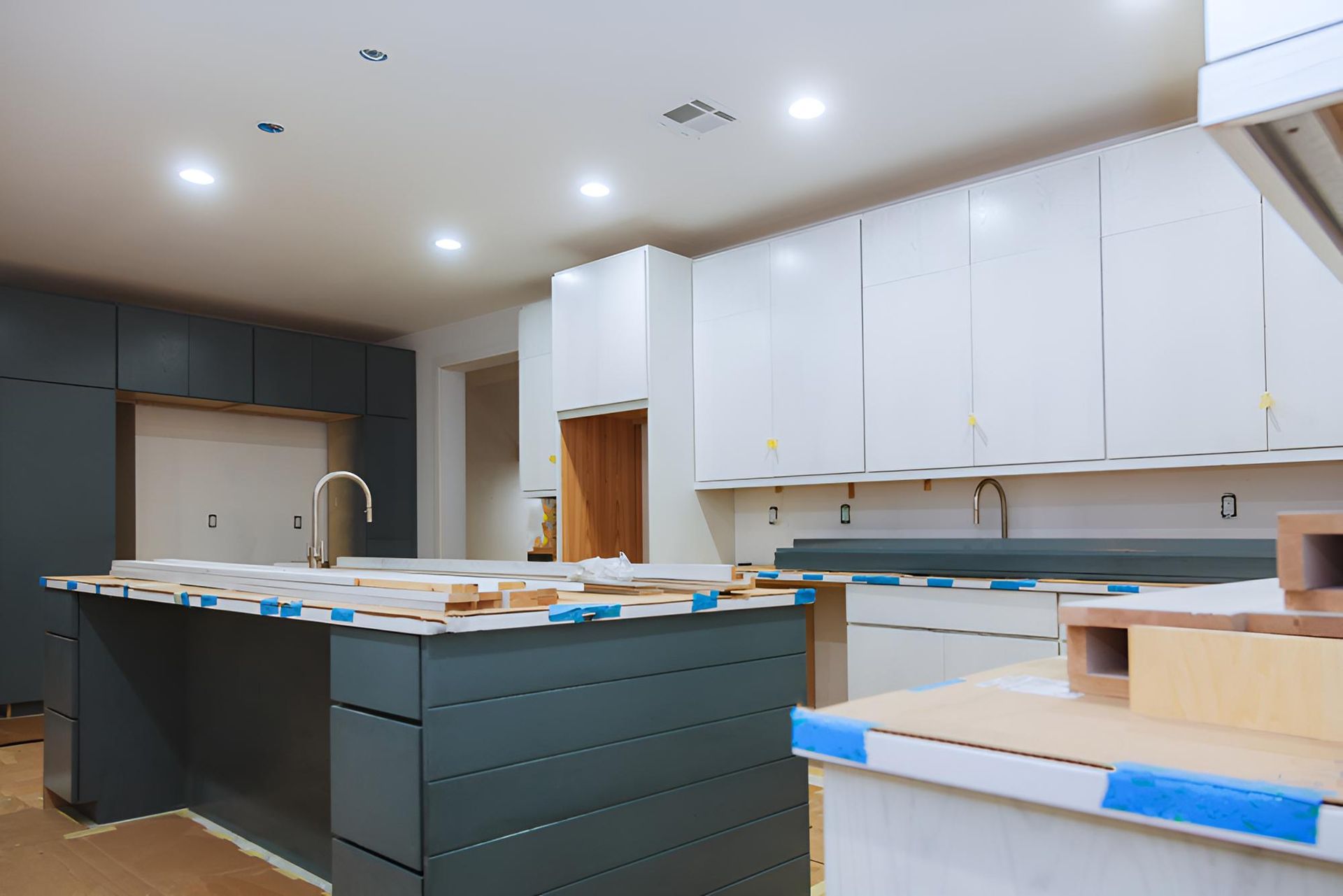 Kitchen Under Construction With White Cabinets — Luke Barry Plumbing in Pimpama, QLD