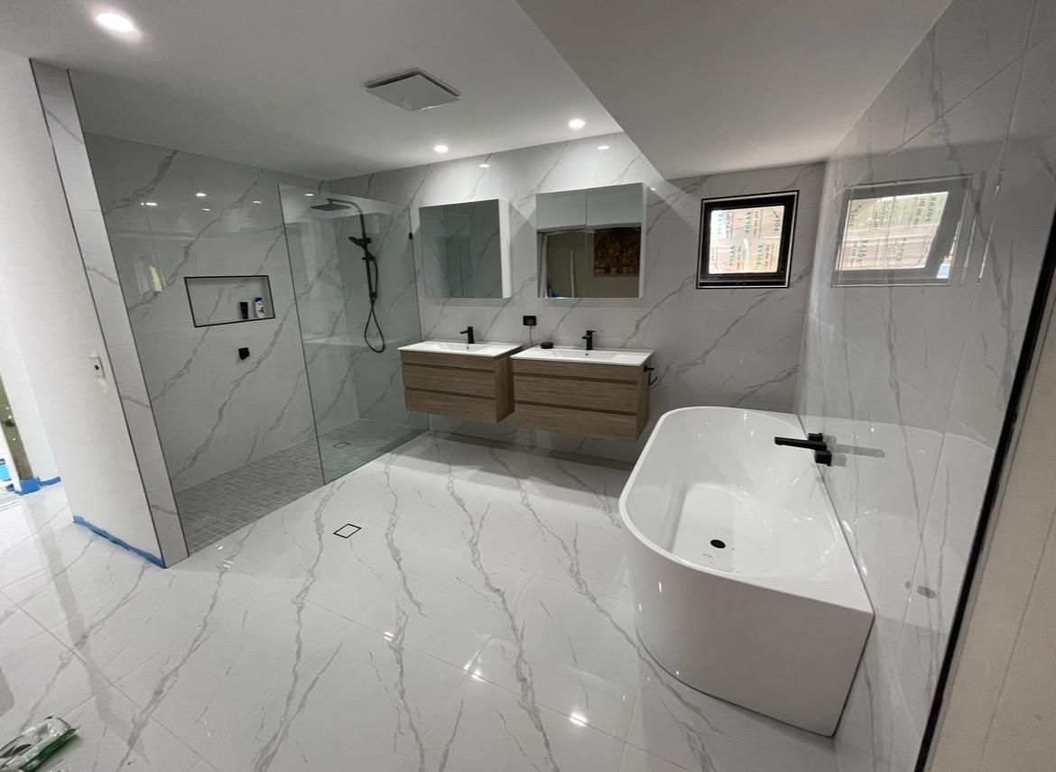 Bathroom With Two Sinks, a Bathtub and a Walk in Shower — Luke Barry Plumbing in Robina, QLD