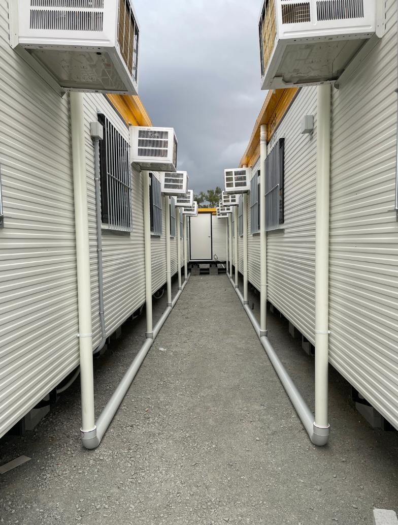 Row of Buildings With Pipe — Luke Barry Plumbing in Miami, QLD