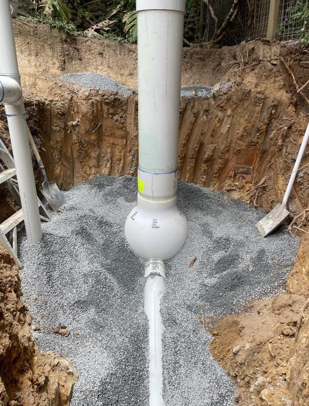Pipe is Being Installed in a Hole in the Ground — Luke Barry Plumbing in Mermaid Beach, QLD