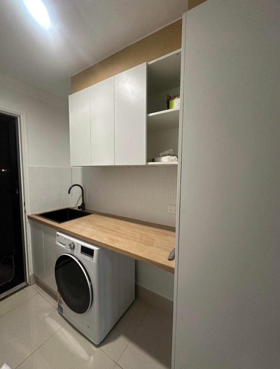 Laundry Room With a Washer and Dryer and a Sink — Luke Barry Plumbing in Robina, QLD