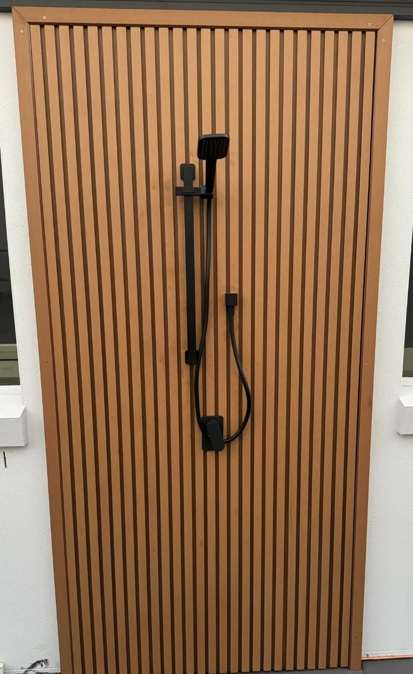 Wooden Door With a Shower Head Attached to It — Luke Barry Plumbing in Mermaid Beach, QLD