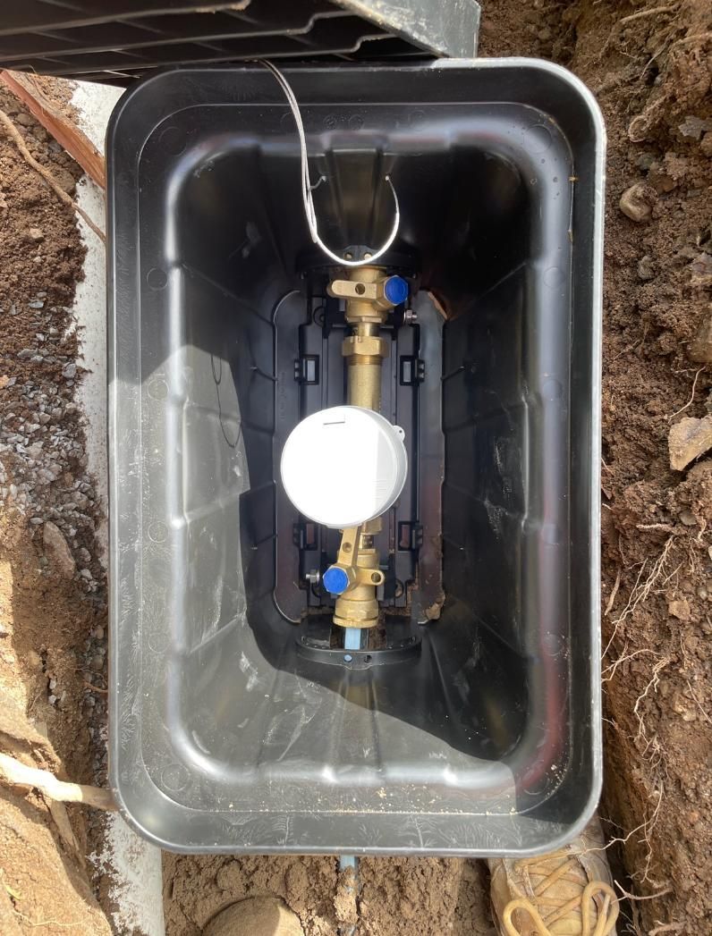 Water Meter is Sitting Inside of a Plastic Box — Luke Barry Plumbing in Mermaid Beach, QLD