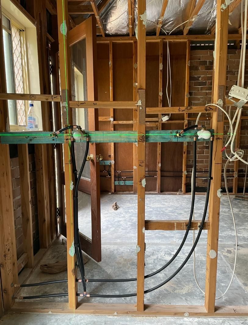 Room With a Wooden Frame and Wires Coming — Luke Barry Plumbing in Tugun, QLD