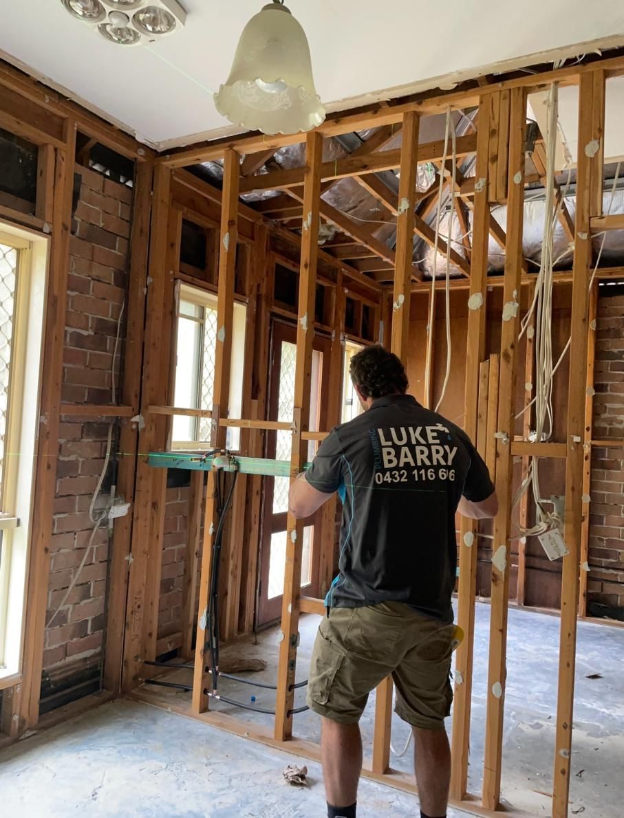 Man Wearing a Luke Barry Shirt — Luke Barry Plumbing in Palm Beach, QLD