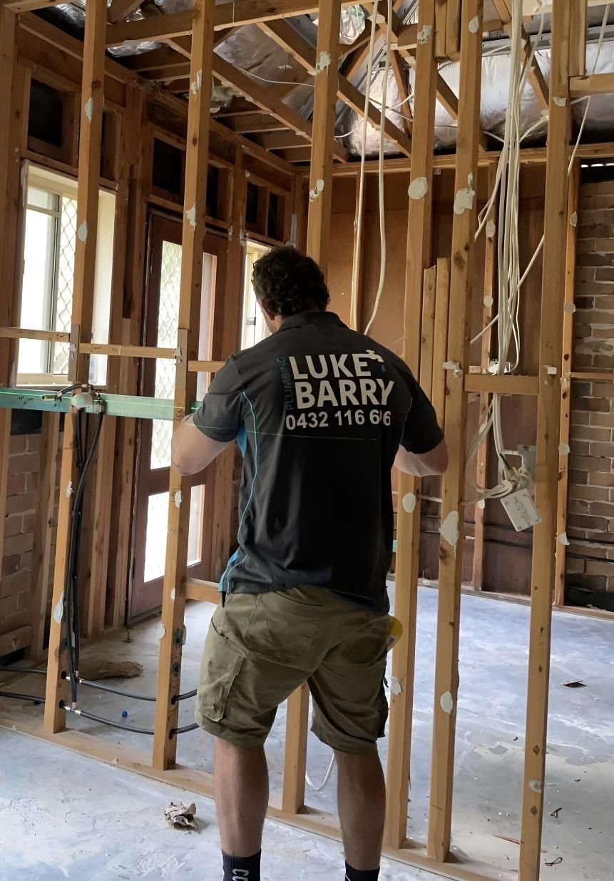 Man Wearing a Luke Barry Shirt Renovating a Room — Luke Barry Plumbing in Mudgeeraba, QLD