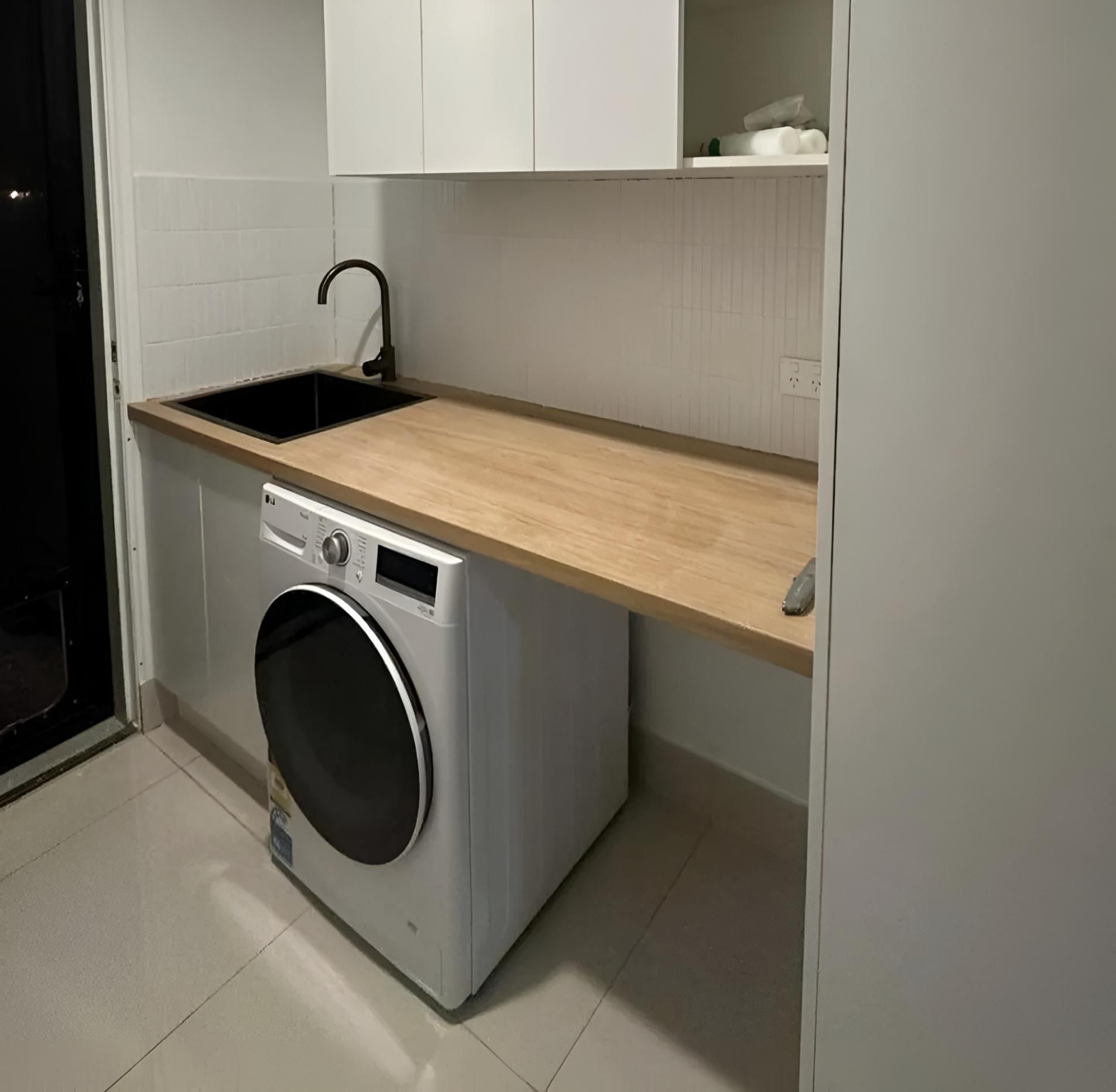 Laundry Room With a Washer and Dryer and a Sink — Luke Barry Plumbing in Mudgeeraba, QLD