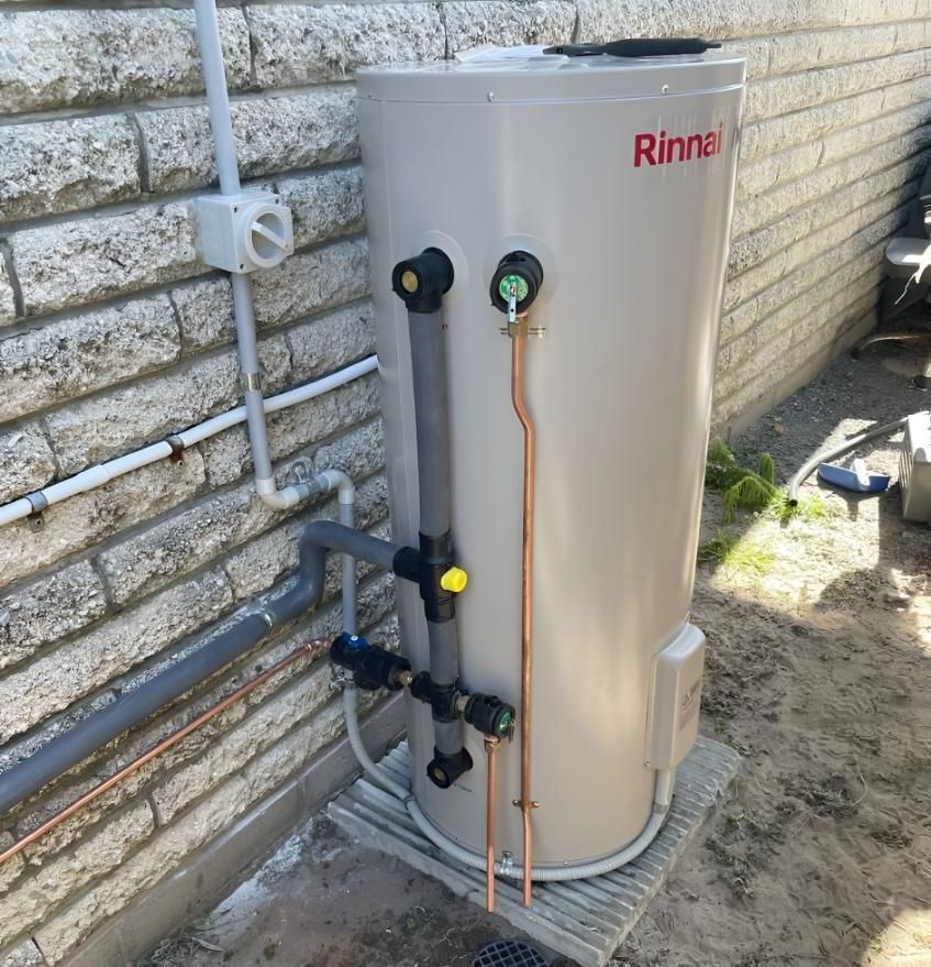 Rinnai Water Heater is Sitting Next to a Brick Wall — Luke Barry Plumbing in Mudgeeraba, QLD