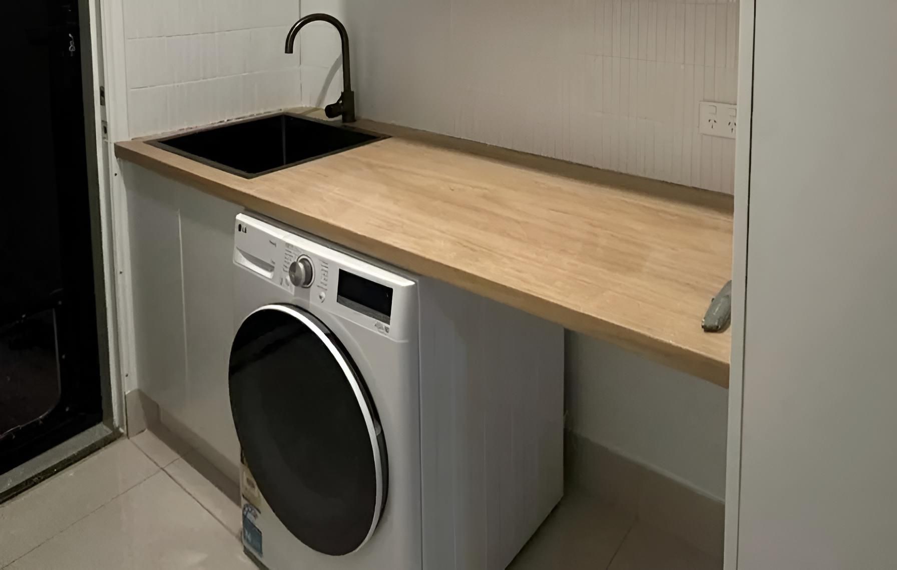 Laundry Room With a Washer and Dryer and a Sink — Luke Barry Plumbing in Mudgeeraba, QLD
