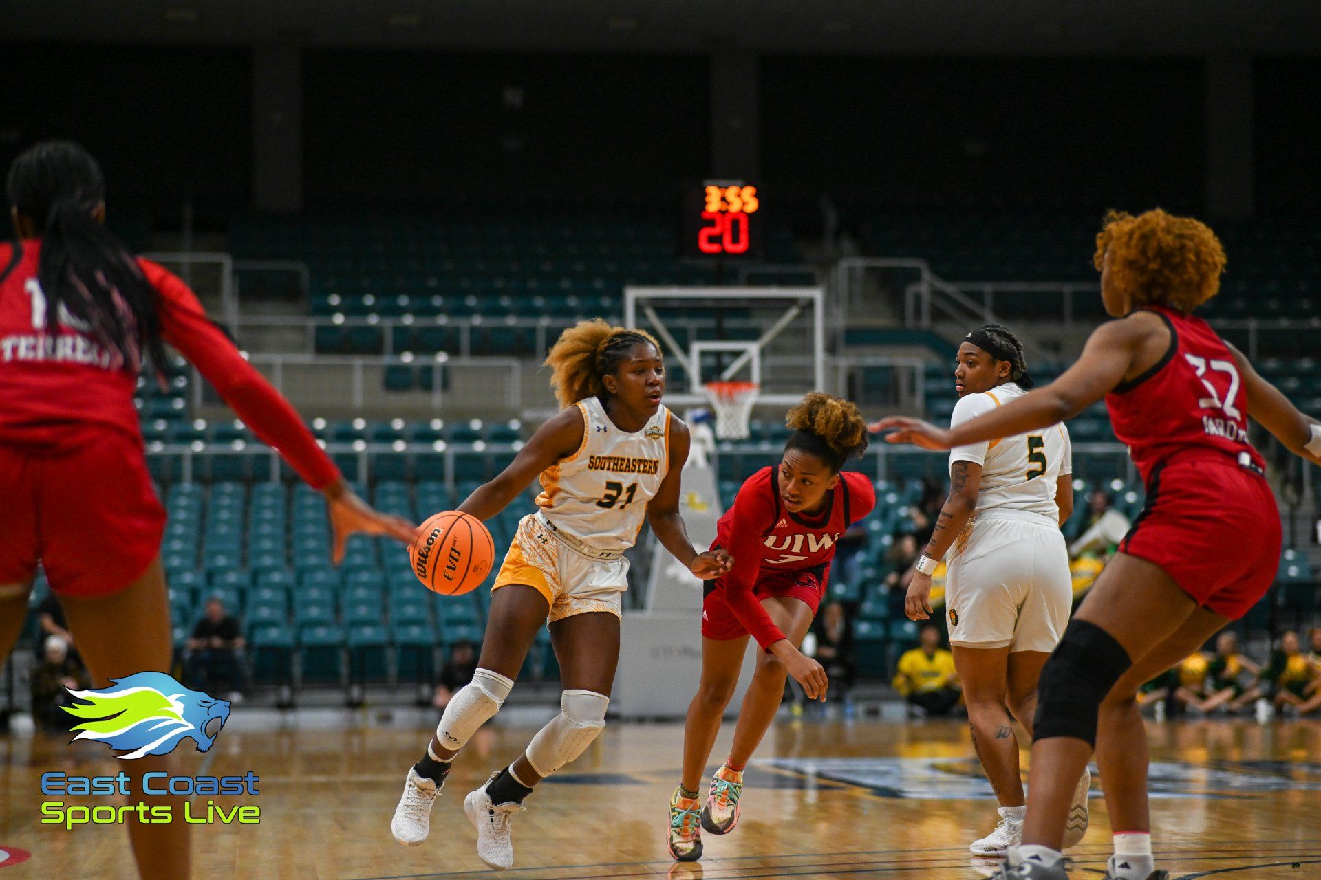 A group of women are playing basketball on a court.