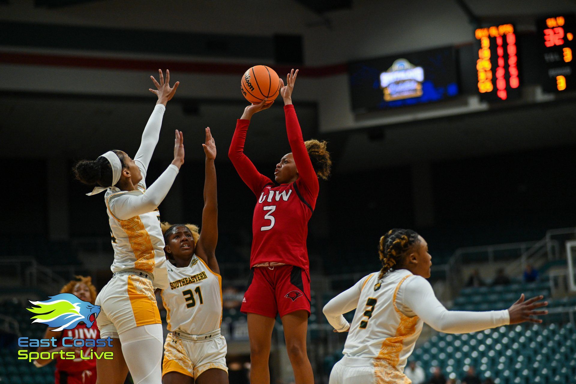 A group of women are playing basketball on a court.