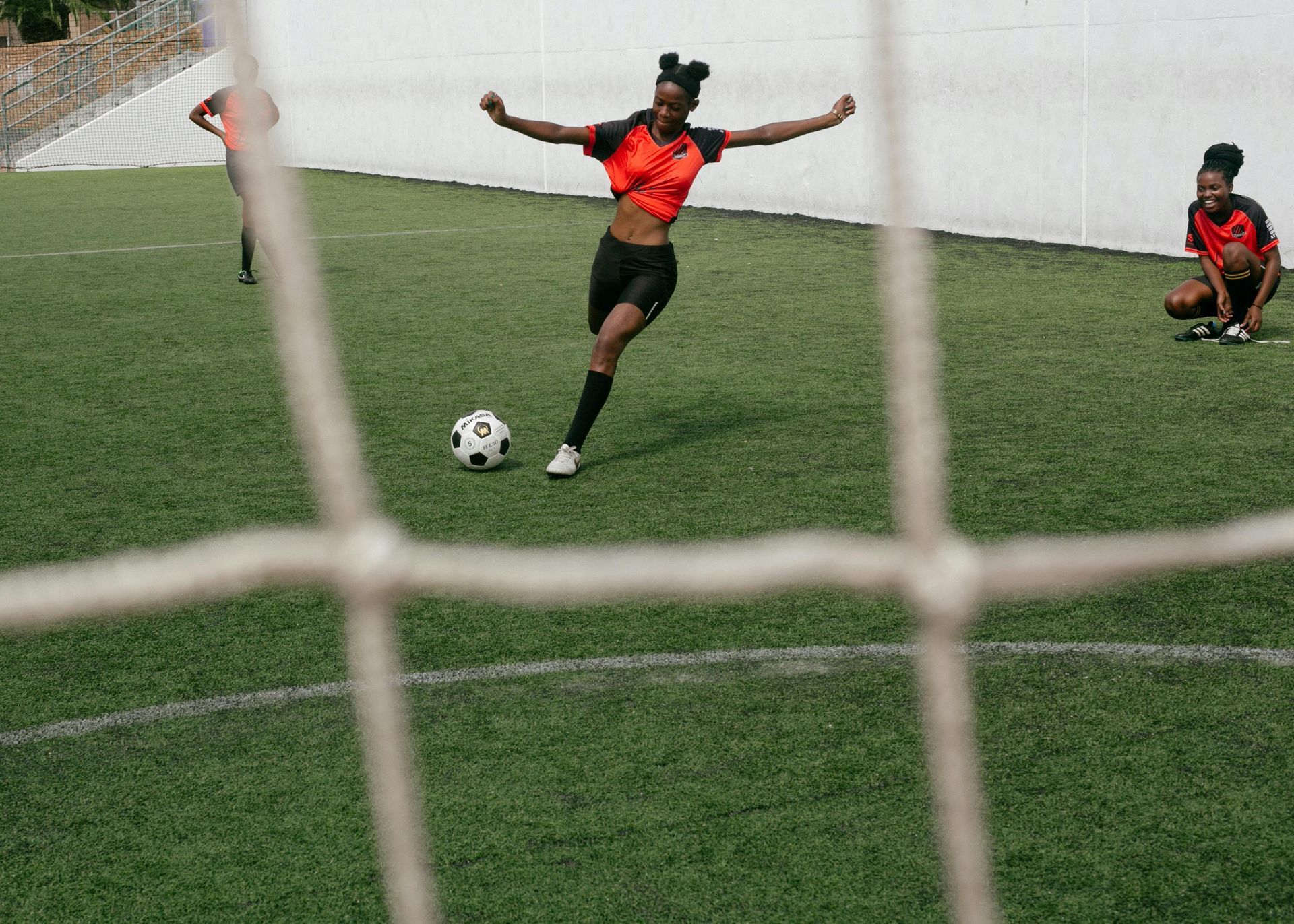 A black woman playing soccer.