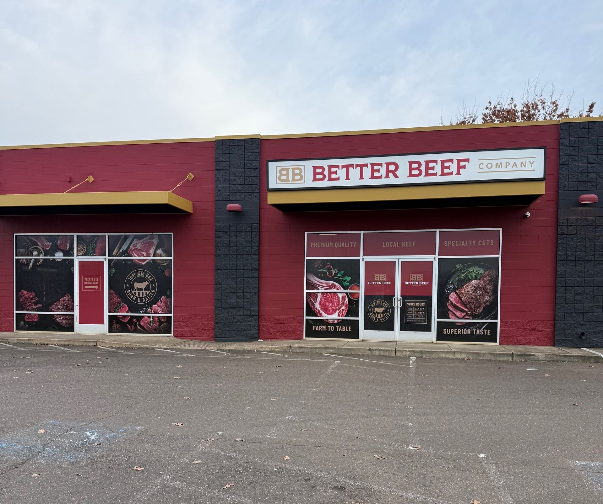 Better Beef storefront with red facade and large windows on a cloudy day