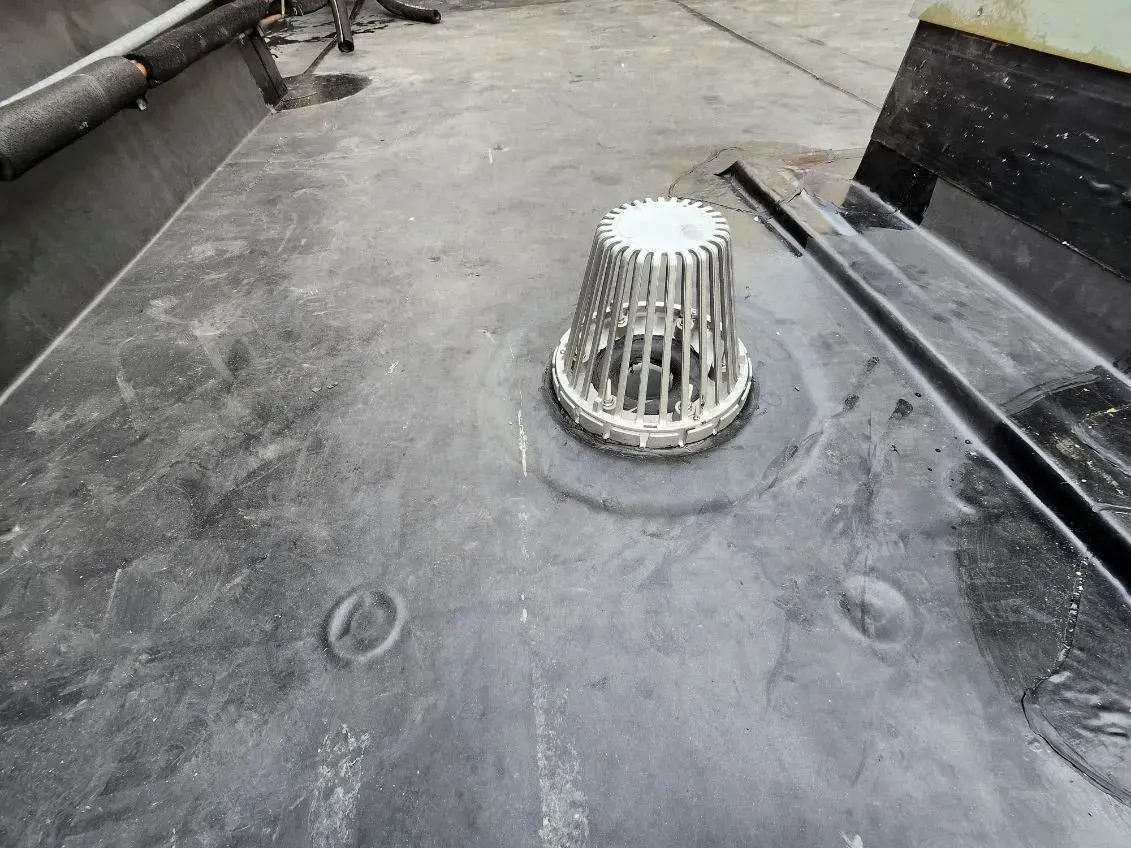 There is a drain on the roof of a building.