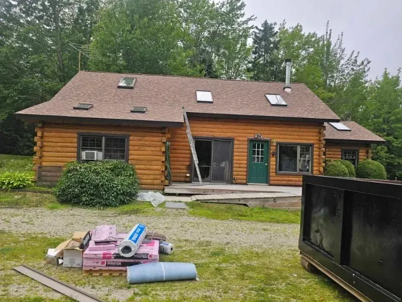 A log cabin is being remodeled with a new roof.