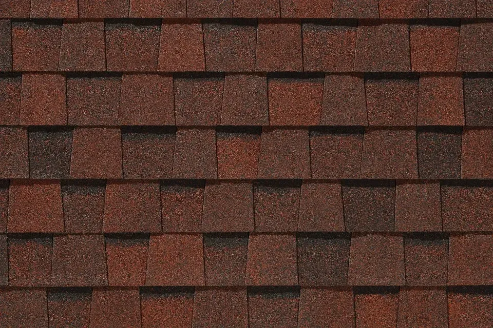 A close up of a row of red shingles on a roof.