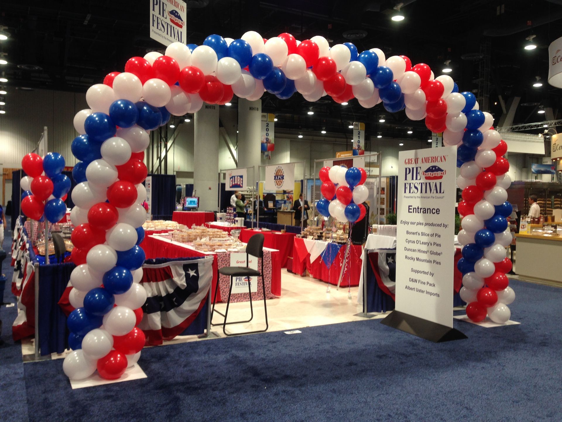 A hallway filled with balloons and a balloon arch.