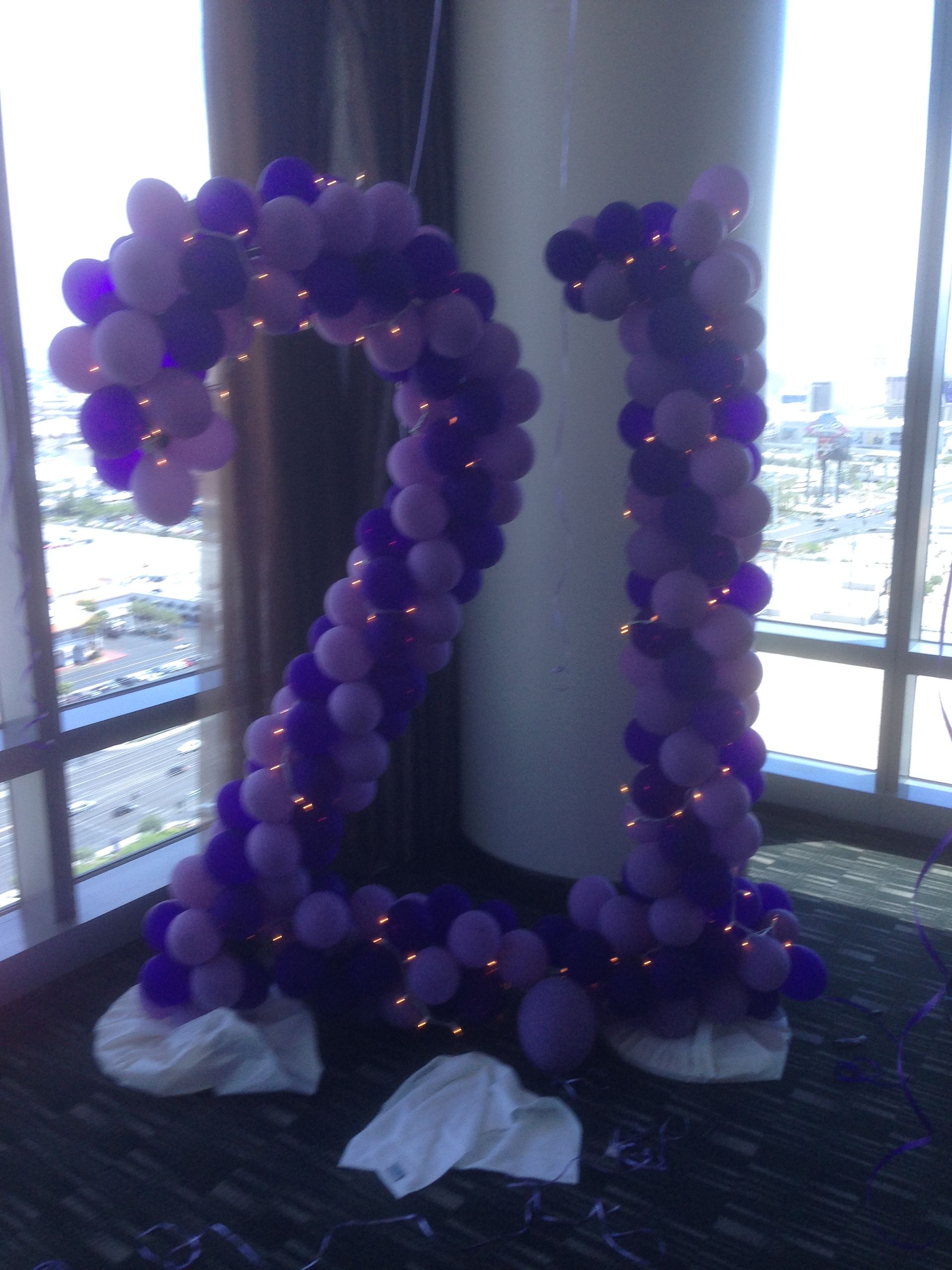A large number 21 made of purple balloons
