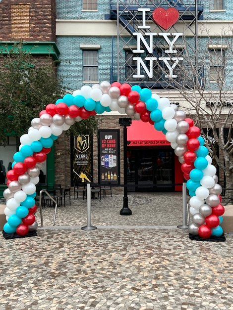 A balloon arch in front of a building that says i love ny ny