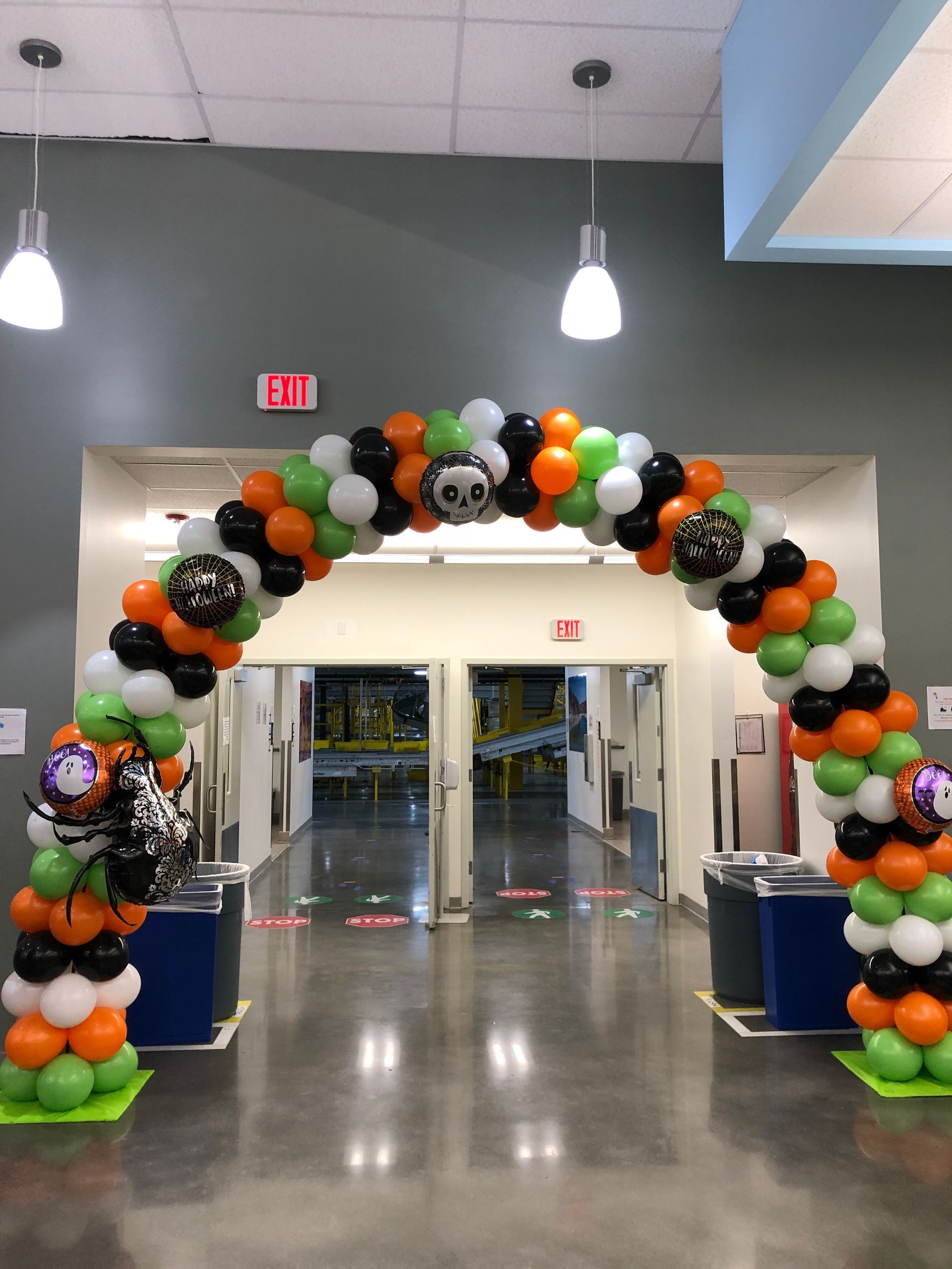 A hallway is decorated with balloons for halloween