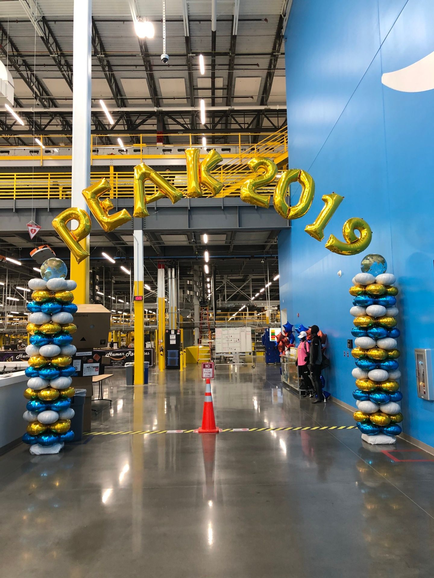 A warehouse with balloons and a sign that says ' congratulations ' on it.