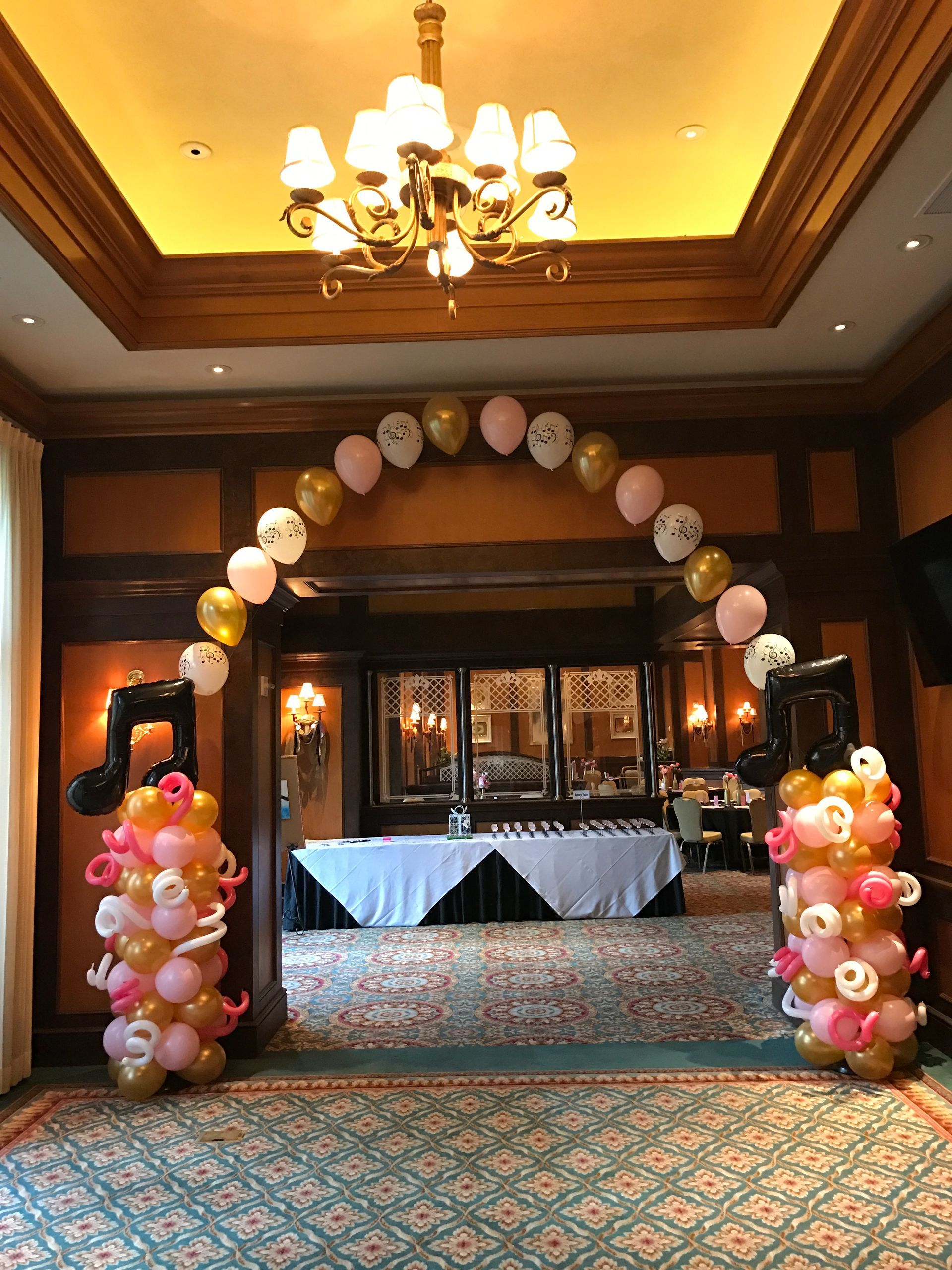 A room filled with balloons and a chandelier.