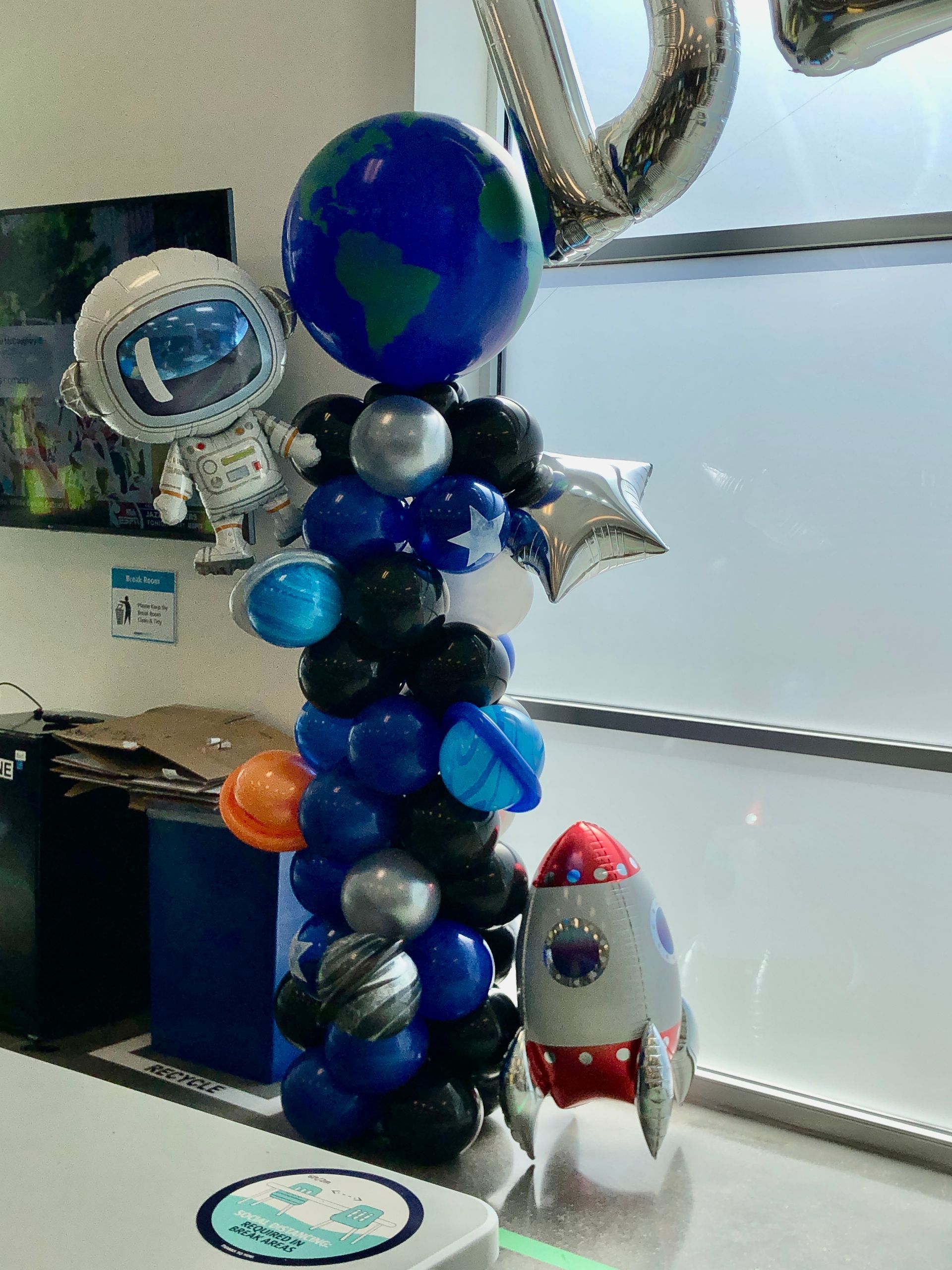 A balloon tower with a rocket and an astronaut on it