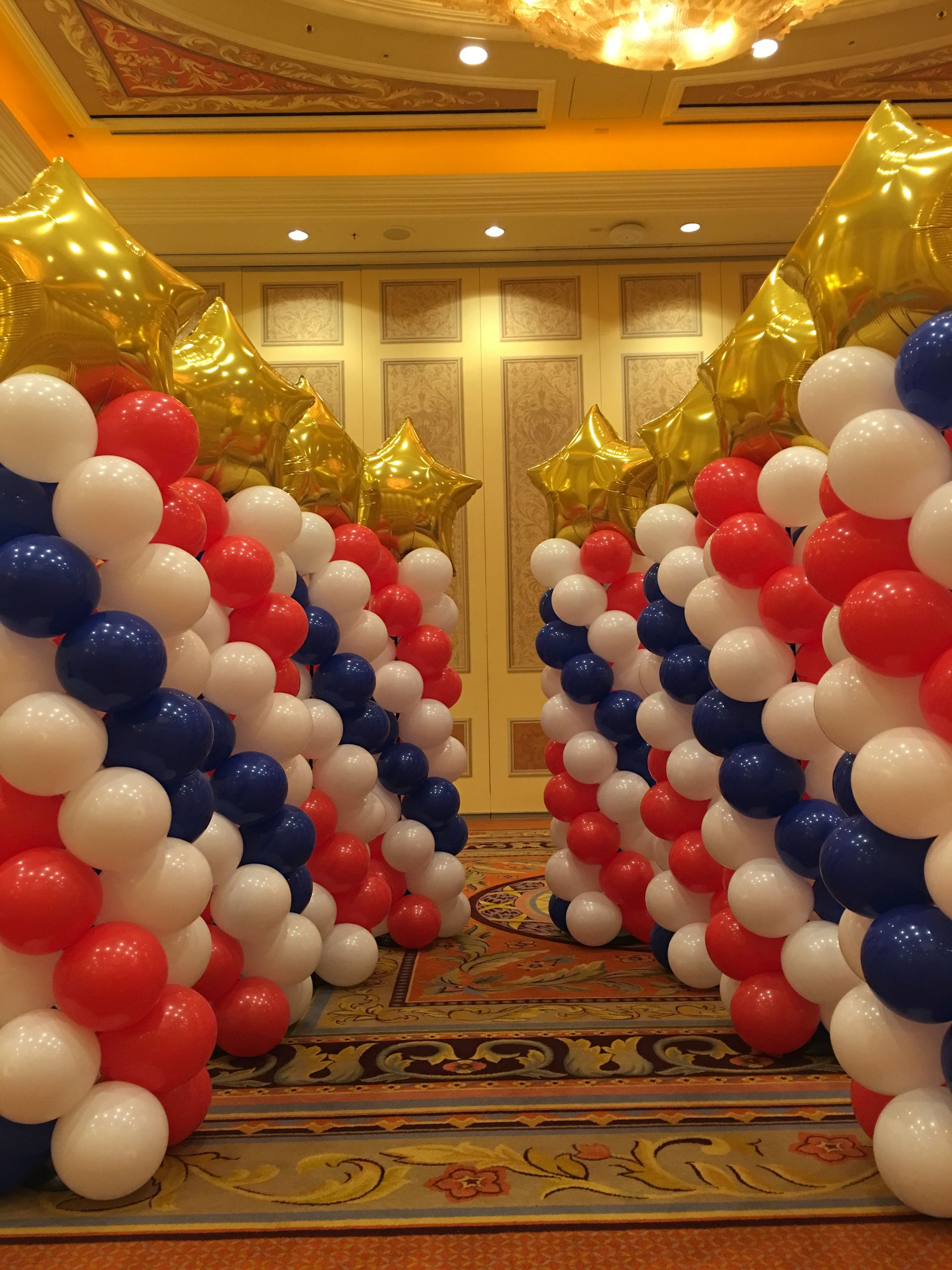 A room filled with red white and blue balloons