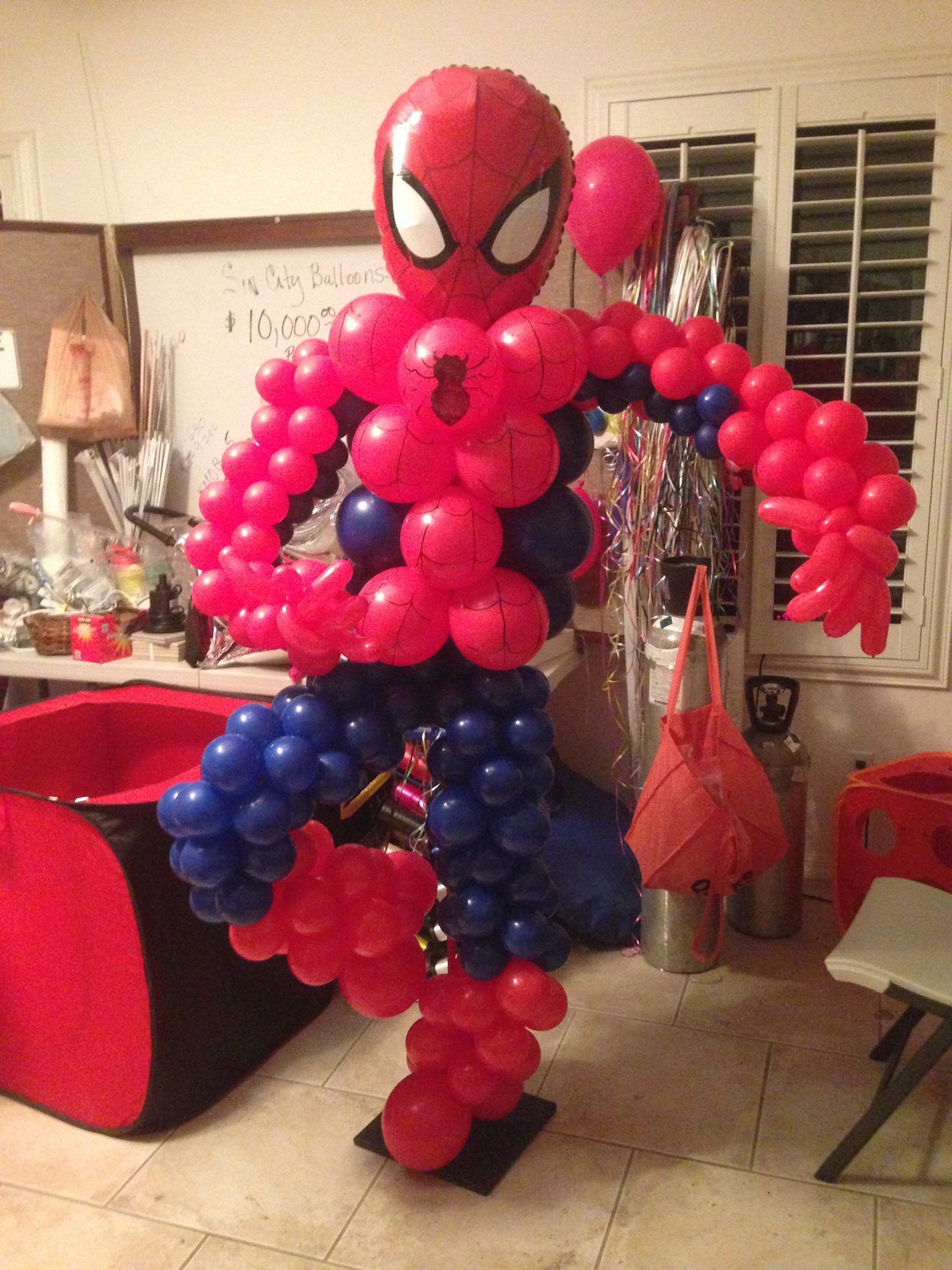 A spiderman made out of red and blue balloons