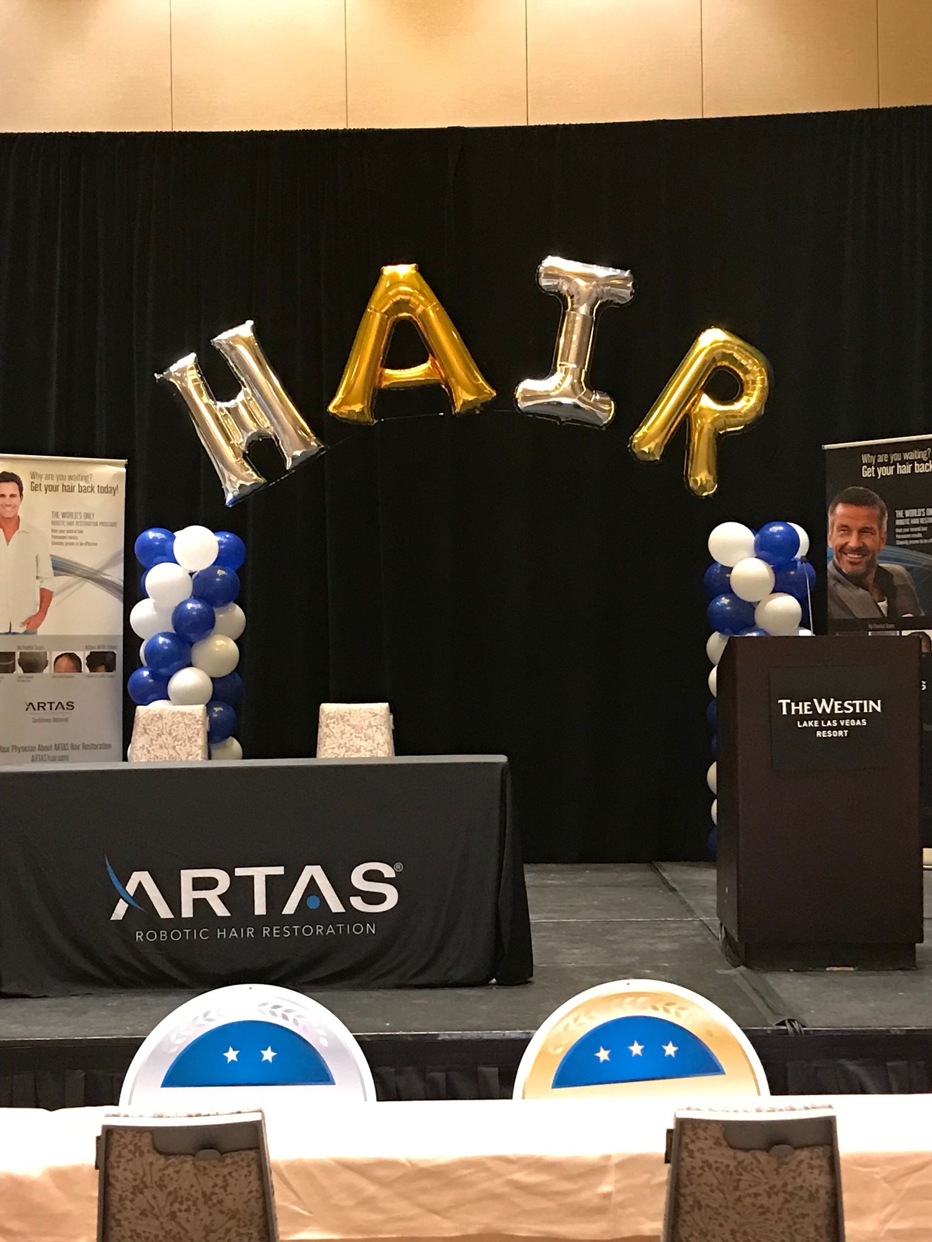 A stage with balloons in the shape of the word hair