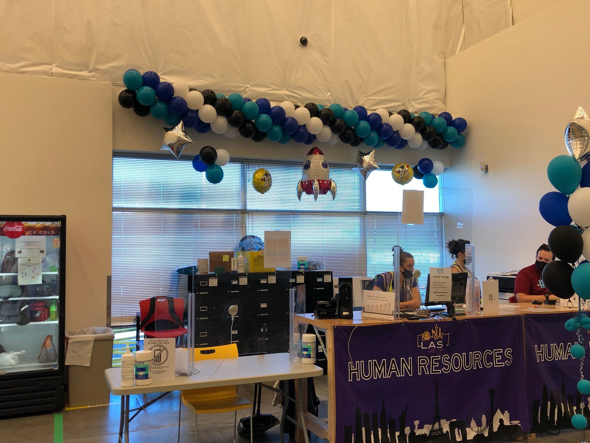 A room with balloons hanging from the ceiling and a sign that says nurse resources