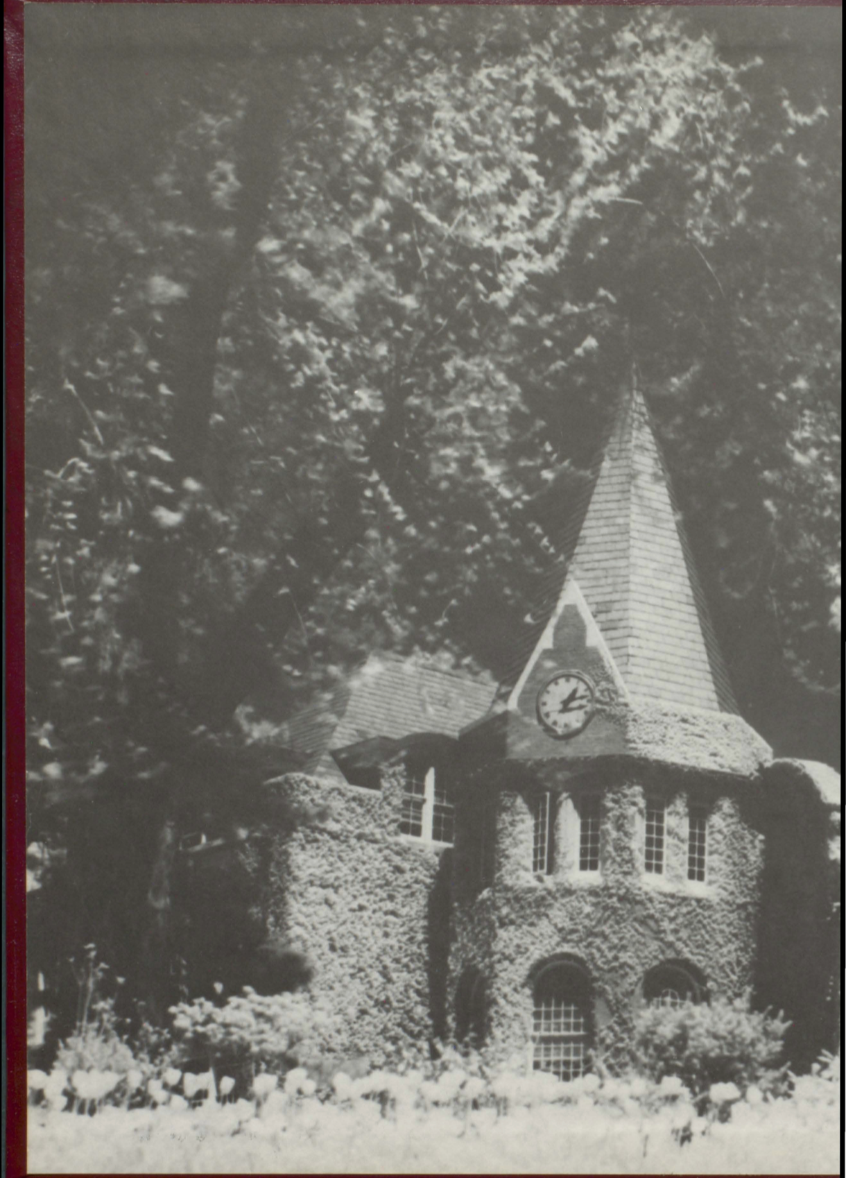 A black and white photo of a church with a clock tower